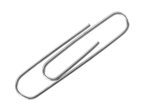 Overheasd photo of mix of paper clips on a white background