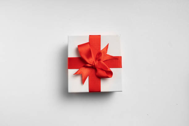 istock White gift box red ribbon on white background 1189843204
