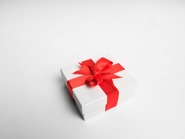 istock White gift box red ribbon on white background 1189843334