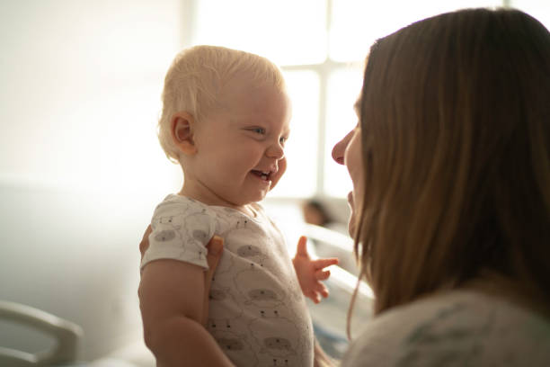 istock Happy mother holding and playing with his son 1189844104