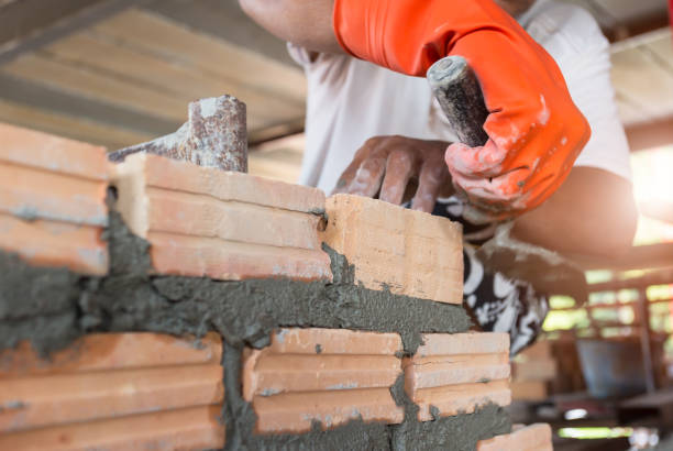 istock Close up of industrial bricklayer installing bricks on construction site 1189844190