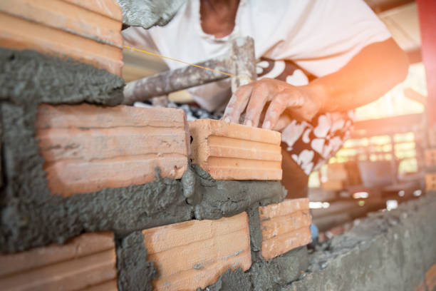 istock Close up of industrial bricklayer installing bricks on construction site 1189844203