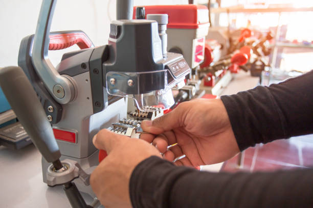 istock Locksmith in workshop makes new key. Professional making key in locksmith. 1189844214