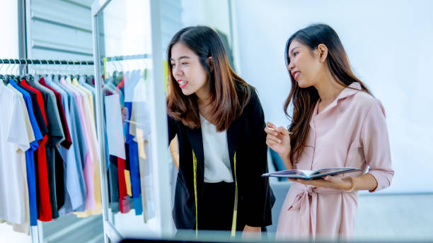 istock Two young designer consult about garment business 1189844338