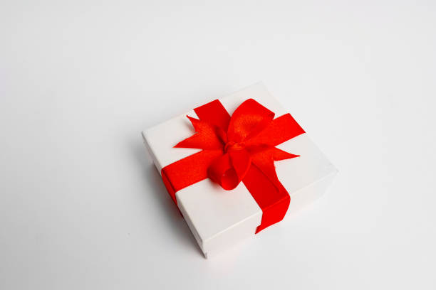 istock White gift box red ribbon on white background 1189844405