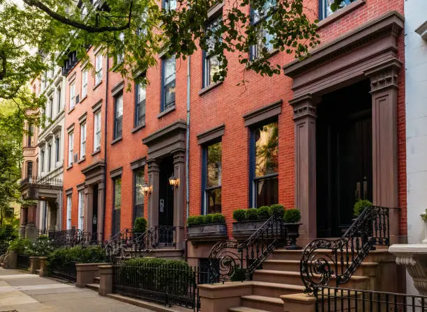 Photo of Brownstone facades & row houses at sunset in an iconic neighborhood of Brooklyn Heights in New York City