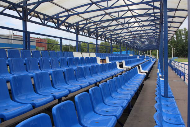 istock long rows of blue empty seats in the bleachers for spectators 1189850882