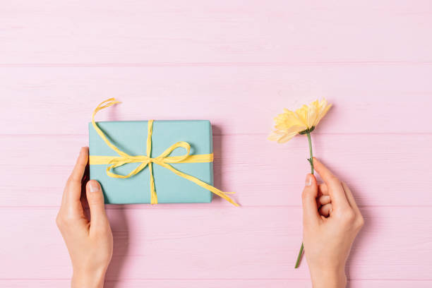 istock Female hands holding gift box 1189851738