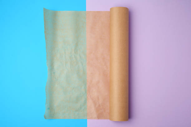 istock unwrapped a roll of brown parchment paper on a colored background 1189852968