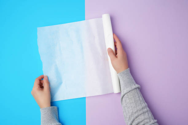 istock two female hands holding a roll of white parchment baking paper 1189854199