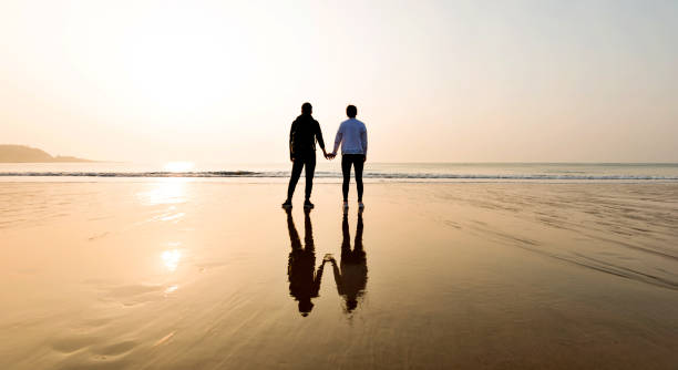 istock Couple holding hands at beach 1189860301