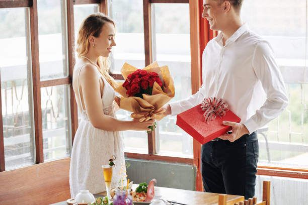 istock Man giving flowers to girlfriend 1189860993