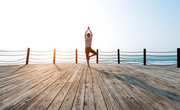 istock Man doing yoga at the seaside 1189861285