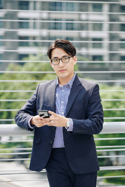 istock Serious businessman with smartphone 1189861875
