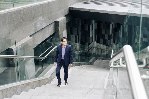 istock Businessman walking up metro station 1189861903