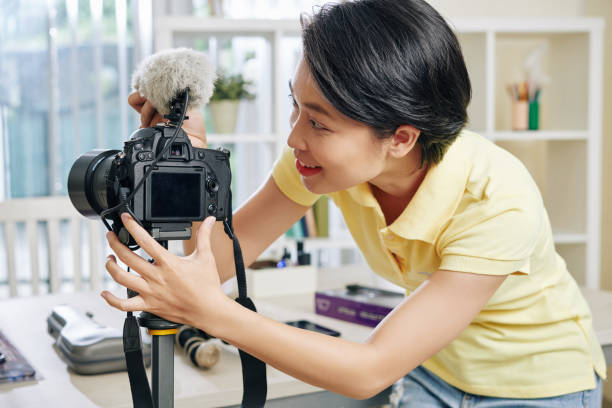 istock Woman installing camera and microphone 1189869163