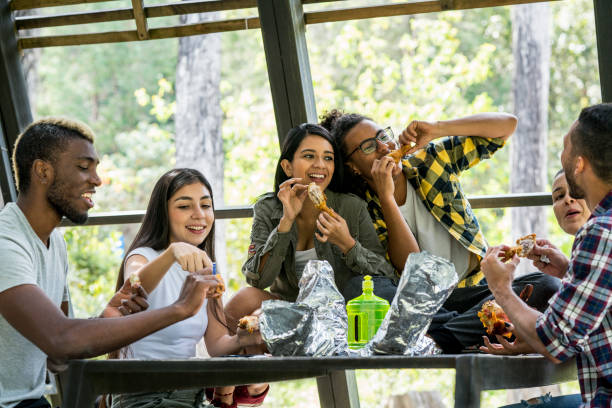 istock Friends laughing while sharing a fried chicken lunch outdoors 1189870896