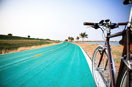 Vintage road bicycle on street with nature field view