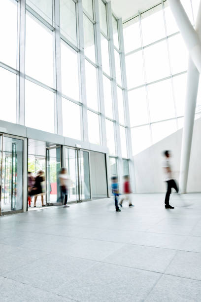 istock Group of people walking in modern building lobby 1189872935