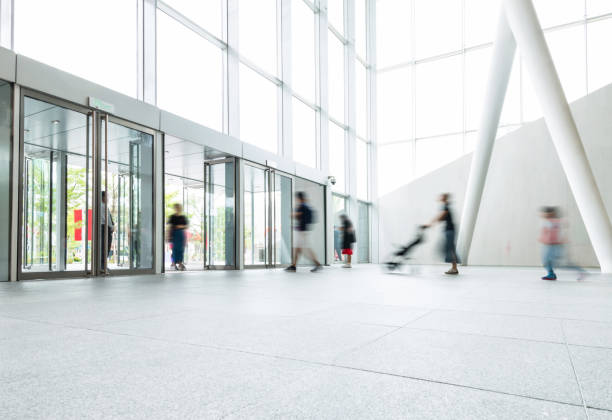 istock Group of people walking in modern building lobby 1189873689