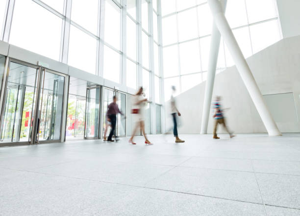 istock Group of people walking in modern building lobby 1189873886