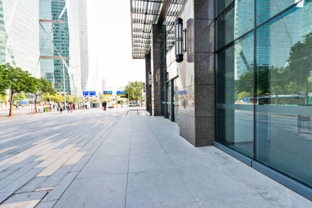 istock Brick road beside modern building 1189874511