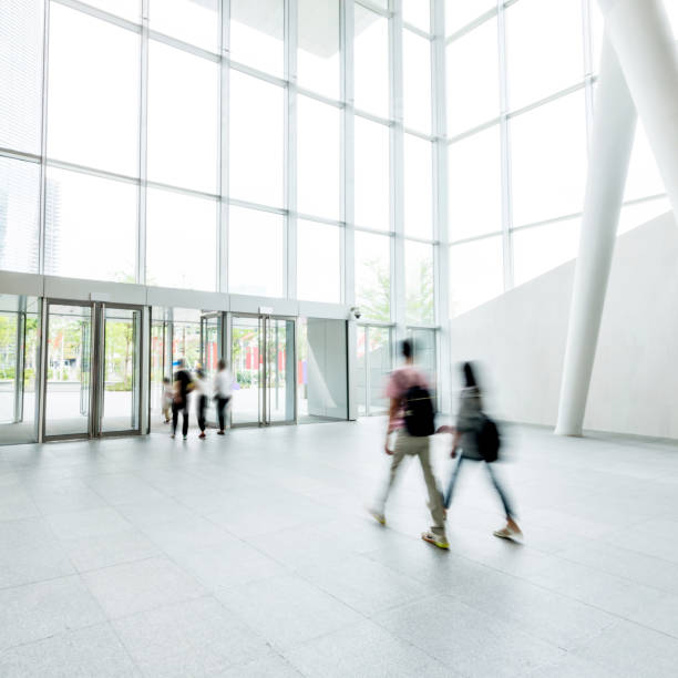 istock Group of people walking in modern building lobby 1189874568