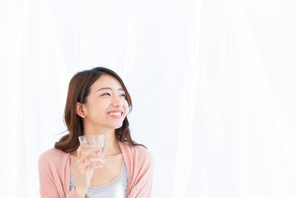 istock asian woman who drinks water 1189874752