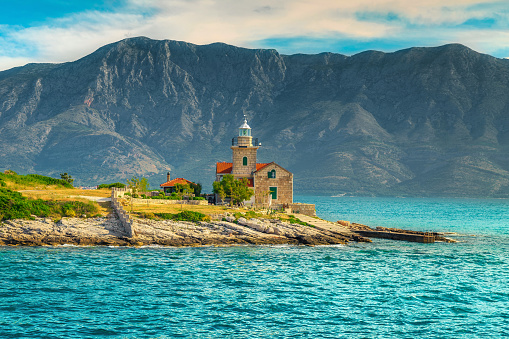Stunning mediterranean lighthouse on the shore and high mountains in background, Sucuraj, Hvar island, Dalmatia, Croatia, Europe