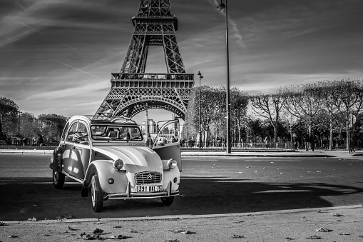 November 22, 2019, Paris. Restored Citroen 2CVs available for personal tours of Paris. They are very popular as a backdrop for tourist selfies in front of the Eiffel Tower. Here they are seen on a clear and bright autumn afternoon.