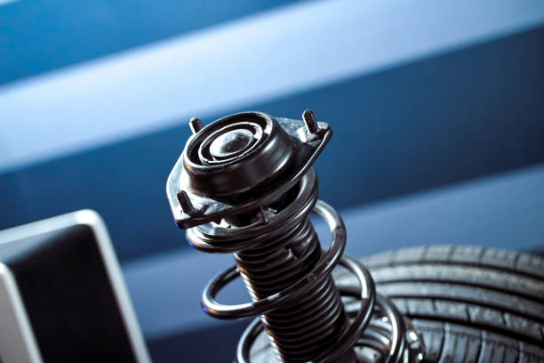 Front wheel of car with shock absorber and coiled spring Front wheel of car with shock absorber and coiled spring shock absorber stock pictures, royalty-free photos & images