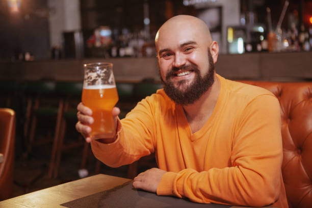 istock Bearded man drinking beer at the pub 1189884790