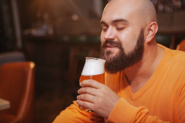 istock Bearded man drinking beer at the pub 1189884859