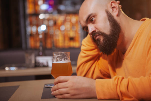 istock Bearded man drinking beer at the pub 1189884943