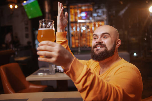 istock Bearded man drinking beer at the pub 1189885046