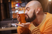 Bearded man drinking beer at the pub