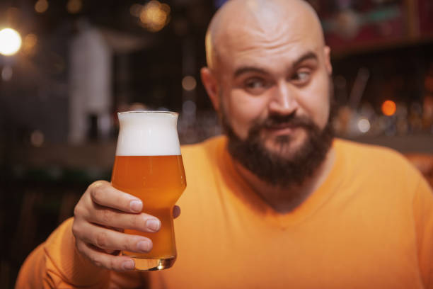 istock Bearded man drinking beer at the pub 1189885050