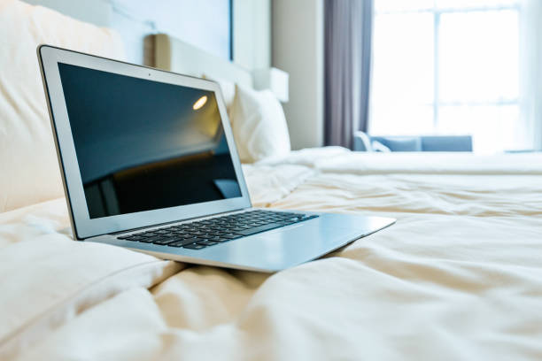 istock Laptop on bed in hotel room 1189885056