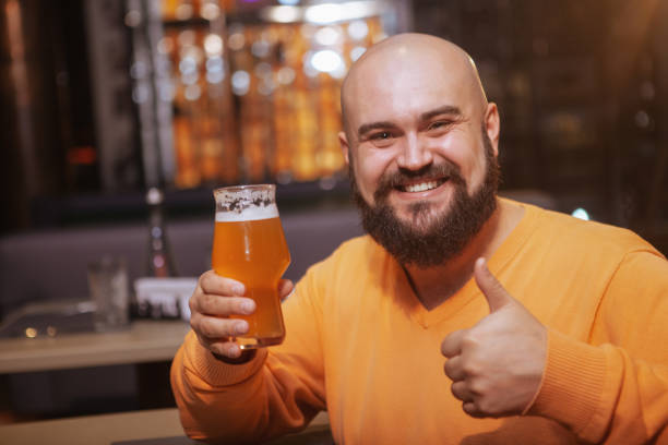 istock Bearded man drinking beer at the pub 1189885128