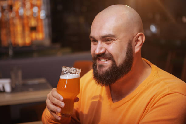 istock Bearded man drinking beer at the pub 1189885132