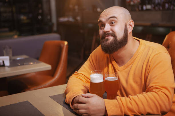 istock Bearded man drinking beer at the pub 1189886431
