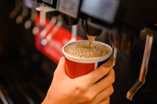 man pours a fizzy drink.sparkling water.cool ice soft drink cola man pours a fizzy drink.sparkling water.cool ice soft drink cola mechanized stock pictures, royalty-free photos & images