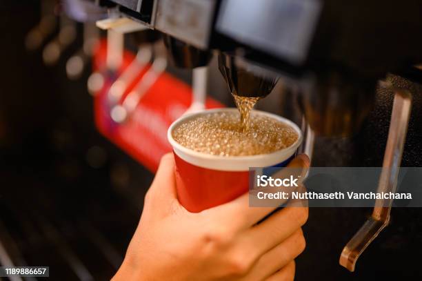 Man Pours A Fizzy Drinksparkling Watercool Ice Soft Drink Cola Stock Photo - Download Image Now