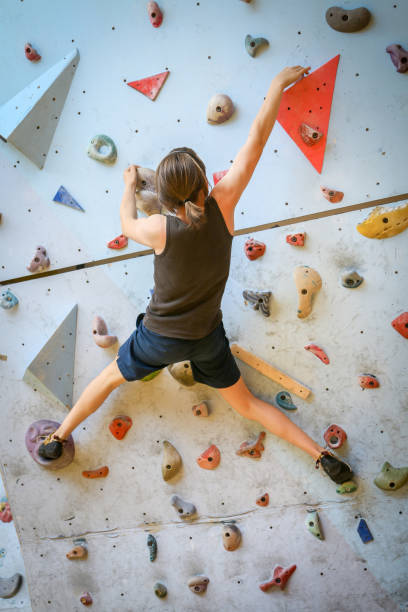 istock Teenage Boy Training Climbing On Indoor Climbing Wall 1189889251