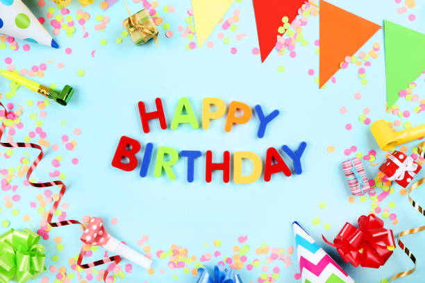 istock Text Happy Birthday by plastic letters with decorations and confetti on blue background 1189889357