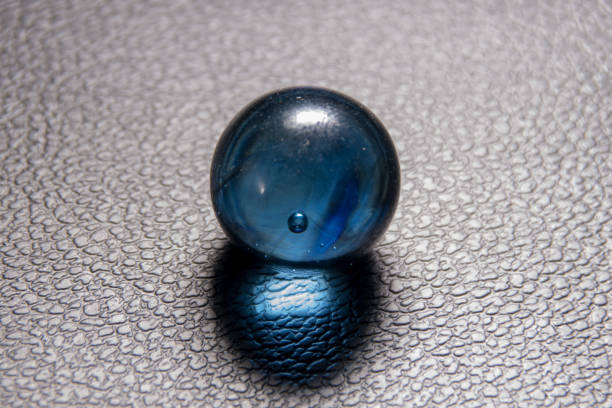 istock glass ball on black leather background 1189890917