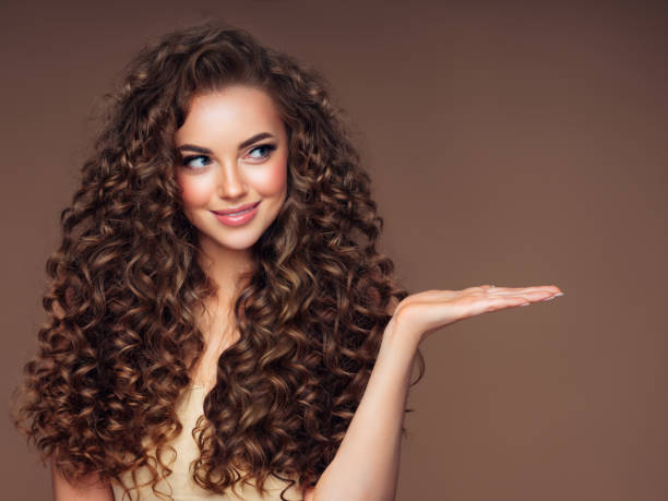 Beautiful woman with voluminous curly hairstyle Beautiful woman with voluminous curly hairstyle long photos stock pictures, royalty-free photos & images