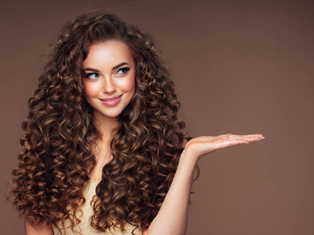 Beautiful woman with voluminous curly hairstyle Beautiful woman with voluminous curly hairstyle wavy hair stock pictures, royalty-free photos & images