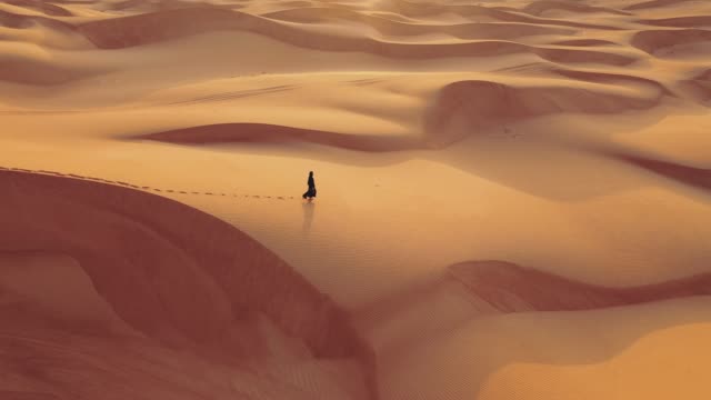 Aerial view from a drone flying next to a woman in abaya United Arab Emirates