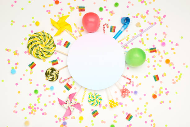 istock Colorful flat lay composition with various party items and candies on white background 1189892320